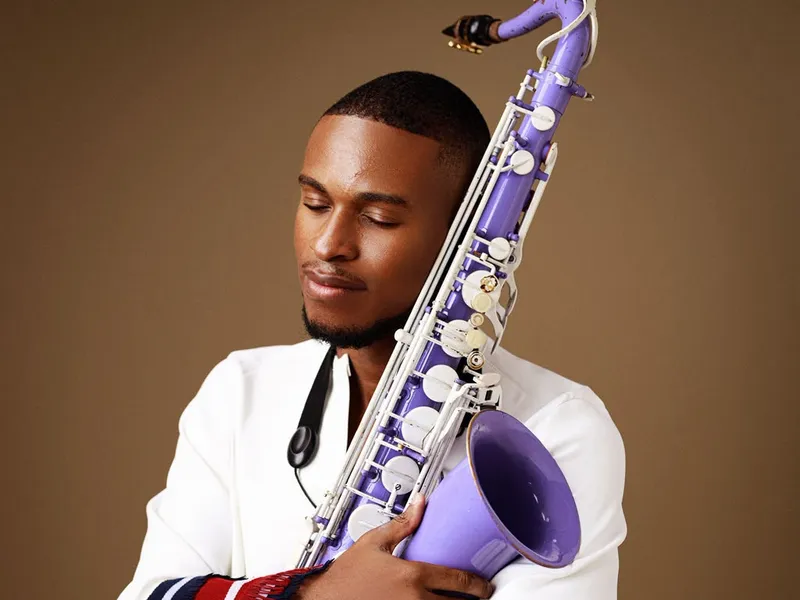 Saxofix holding his lilac saxophone